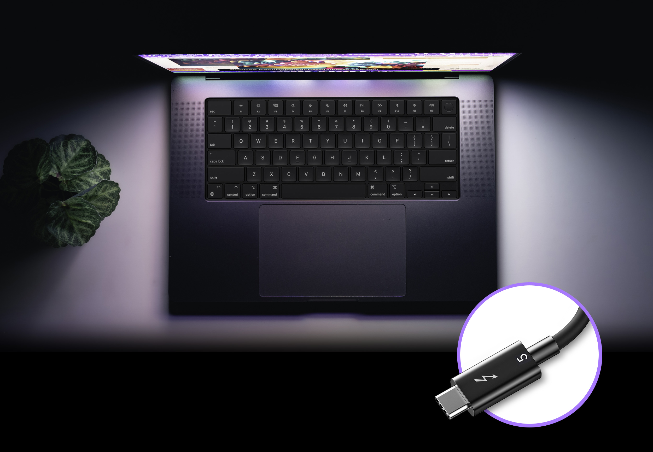 Overview shot of Apple M series MacBook Pro computer with a Thunderbolt 5 cable show next to it.
